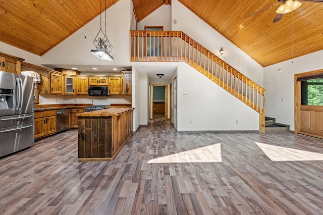 kitchen with pendant lighting, high vaulted ceiling, hardwood / wood-style floors, stainless steel appliances, and wooden ceiling