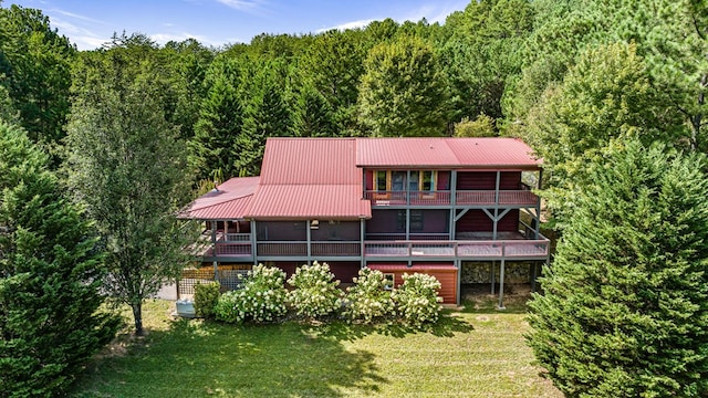 back of house with a yard and a wooden deck