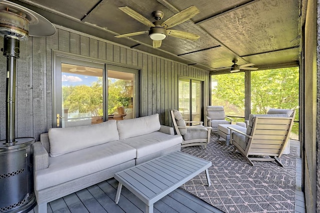 sunroom with ceiling fan and outdoor lounge area