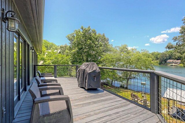 wooden deck featuring a water view