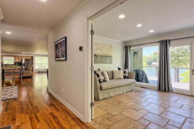 hall with recessed lighting, baseboards, visible vents, and ornamental molding