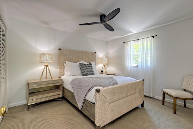 bedroom featuring baseboards, ceiling fan, and carpet