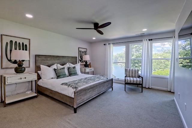 bedroom featuring carpet floors, multiple windows, baseboards, and recessed lighting