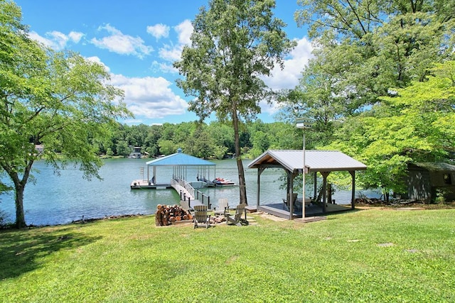 view of dock featuring a lawn and a water view