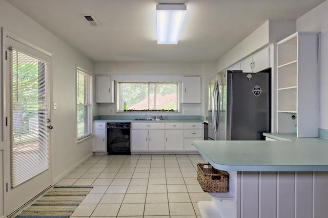 kitchen featuring open shelves, a sink, dishwasher, freestanding refrigerator, and visible vents