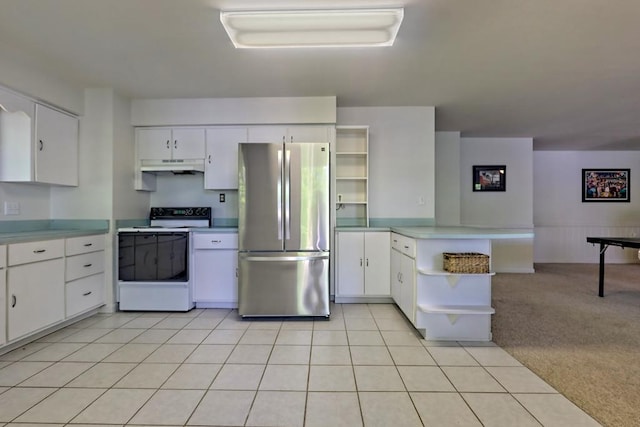 kitchen with range with electric stovetop, open shelves, freestanding refrigerator, a peninsula, and under cabinet range hood