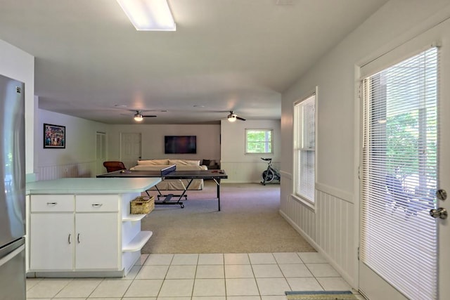 kitchen featuring white cabinets, open shelves, light carpet, open floor plan, and light tile patterned floors