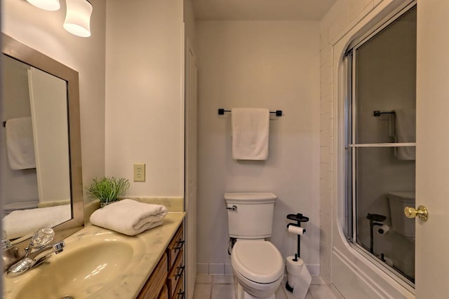 bathroom featuring toilet, tile patterned floors, enclosed tub / shower combo, and vanity