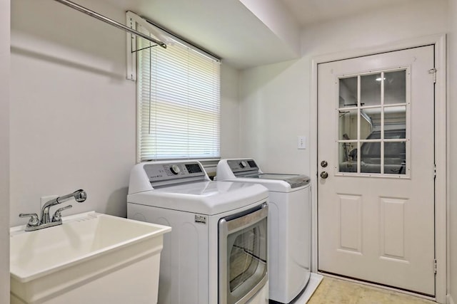 laundry room with separate washer and dryer, laundry area, and a sink