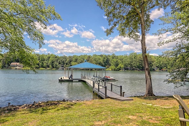 dock area with a yard and a water view