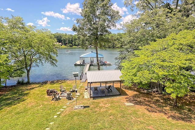 dock area with a lawn and a water view