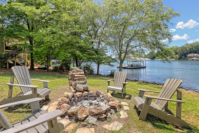 view of yard featuring a water view and an outdoor fire pit