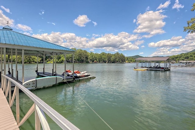 dock area with boat lift and a water view