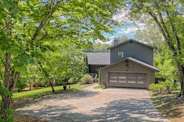 view of front of home with a shingled roof, aphalt driveway, and a chimney