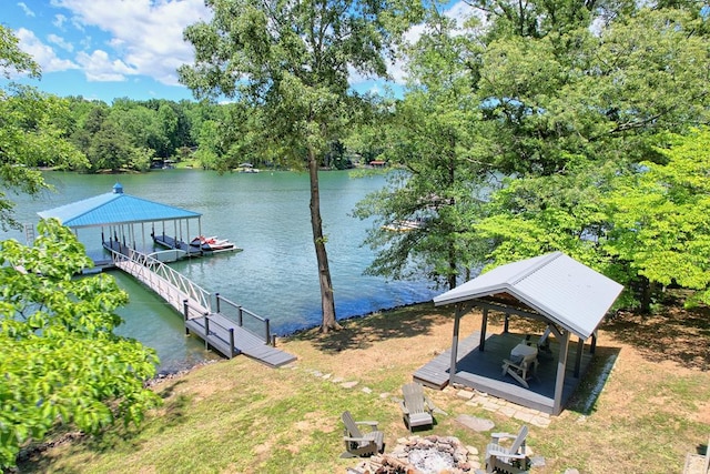 dock area featuring a water view and a fire pit