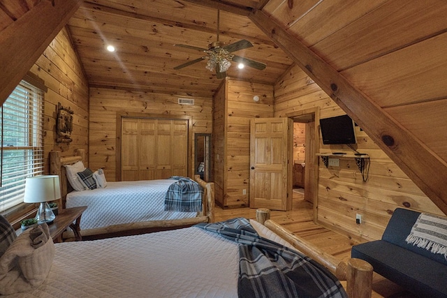 bedroom featuring wood ceiling, wood walls, and vaulted ceiling