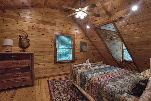 bedroom with wood walls, wood-type flooring, lofted ceiling, and wood ceiling