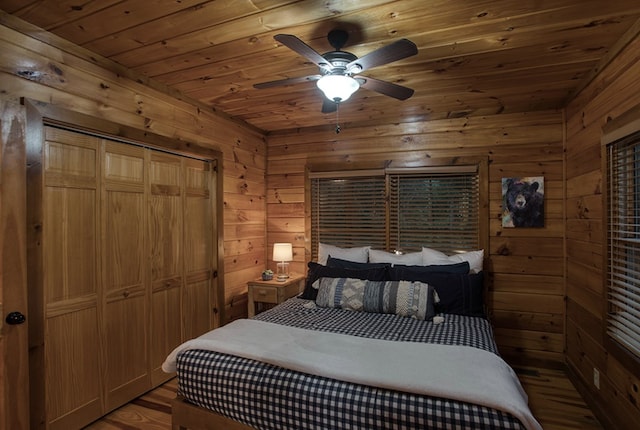 bedroom featuring wood-type flooring, wood walls, and wooden ceiling