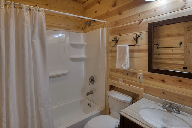 full bathroom with wood walls, toilet, vanity, and shower / bath combo