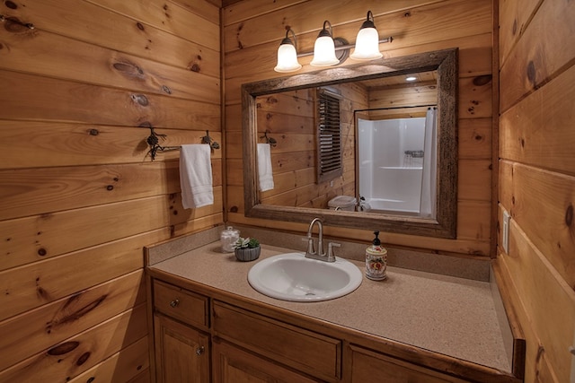 bathroom featuring vanity and wooden walls