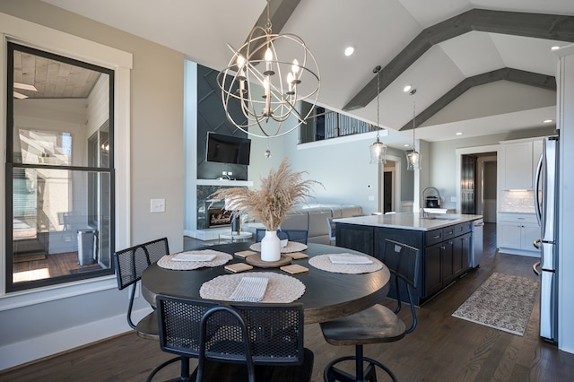 dining space with a healthy amount of sunlight, an inviting chandelier, high vaulted ceiling, and dark hardwood / wood-style flooring