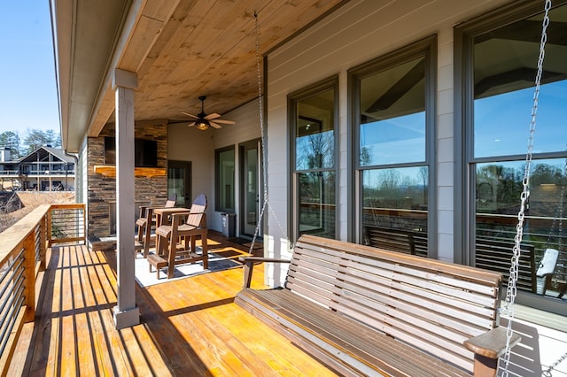 wooden deck featuring ceiling fan