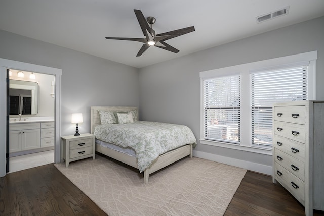 bedroom featuring wood-type flooring, sink, ceiling fan, and ensuite bathroom