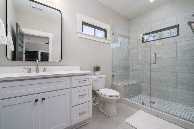 bathroom featuring a shower with shower door, toilet, plenty of natural light, and vanity