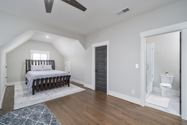 bedroom featuring vaulted ceiling, connected bathroom, ceiling fan, and dark hardwood / wood-style floors