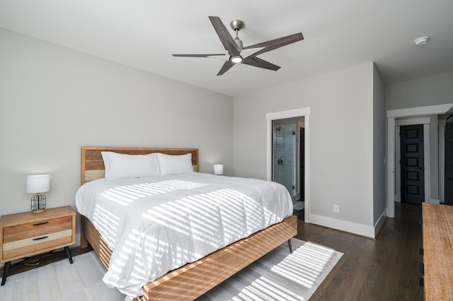 bedroom with connected bathroom, wood finished floors, baseboards, and ceiling fan