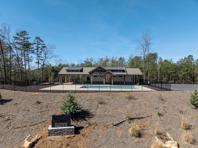 back of house with a fenced in pool and a patio