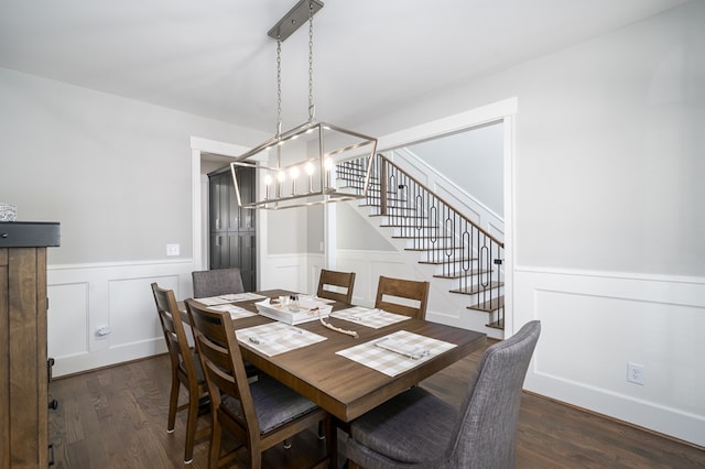 dining area with an inviting chandelier and dark hardwood / wood-style flooring