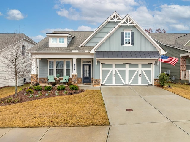 craftsman-style home with a garage and a front lawn