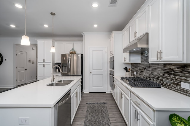 kitchen featuring pendant lighting, white cabinetry, appliances with stainless steel finishes, and a kitchen island with sink