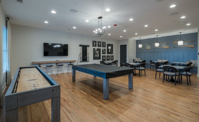 game room featuring a chandelier and light hardwood / wood-style flooring