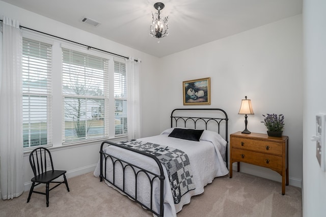 carpeted bedroom with a chandelier and multiple windows