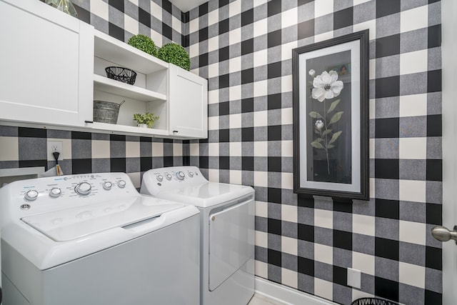 washroom featuring cabinets and washer and dryer