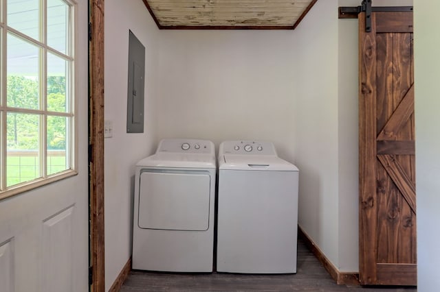 washroom featuring dark wood-type flooring, a barn door, washer and dryer, electric panel, and wood ceiling