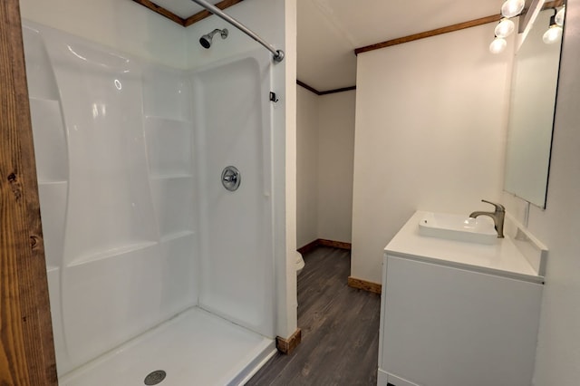 bathroom featuring vanity, hardwood / wood-style flooring, and a shower