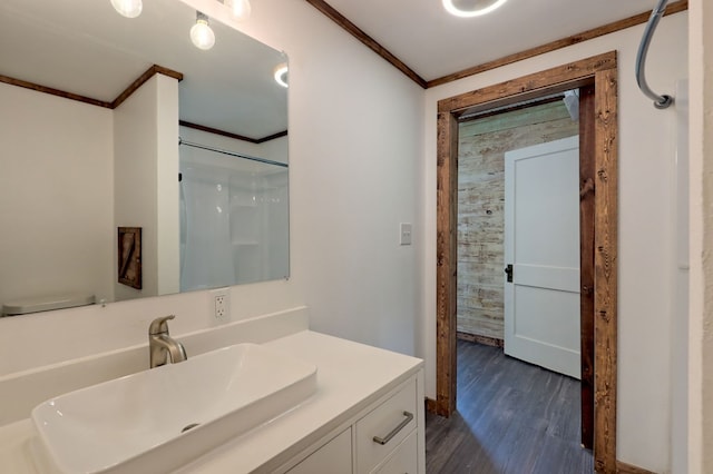 bathroom with vanity, ornamental molding, toilet, and hardwood / wood-style floors