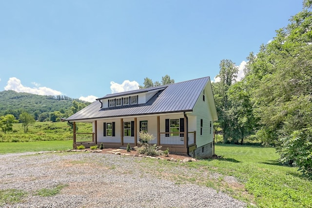 view of front of home featuring covered porch and a front lawn