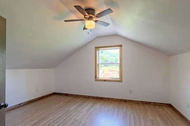 additional living space featuring light hardwood / wood-style flooring, lofted ceiling, and ceiling fan