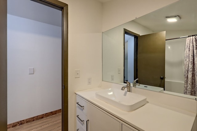 bathroom with hardwood / wood-style flooring and vanity