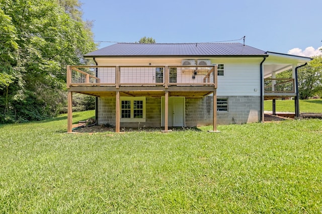 rear view of property with a deck and a lawn