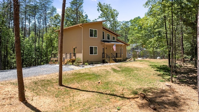 rear view of property featuring a yard