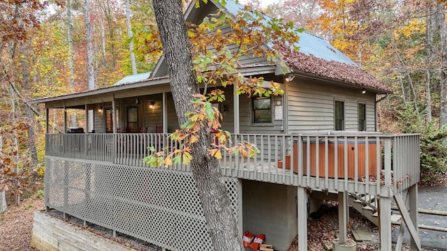 view of property exterior with a wooden deck