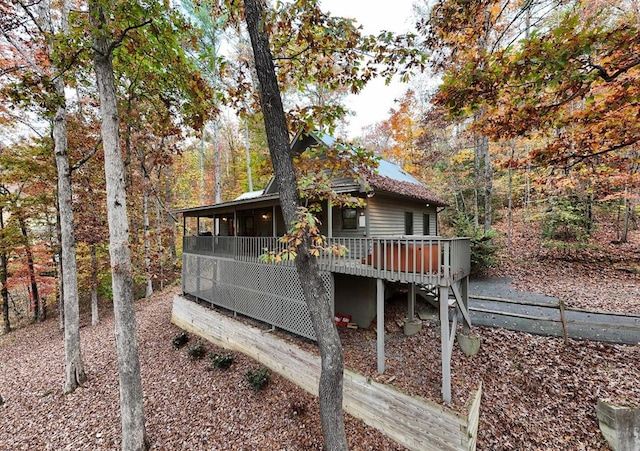 rear view of house featuring a deck