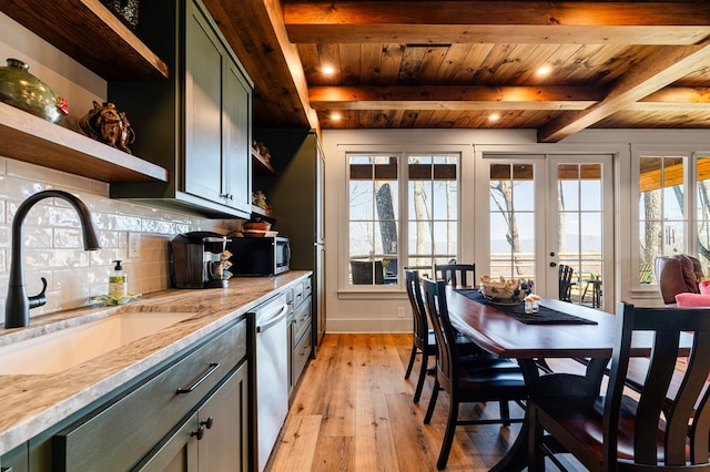 kitchen with decorative backsplash, appliances with stainless steel finishes, beamed ceiling, open shelves, and a sink