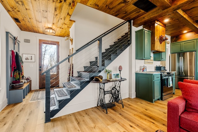 kitchen with wood ceiling, stainless steel appliances, light countertops, light wood-type flooring, and green cabinets