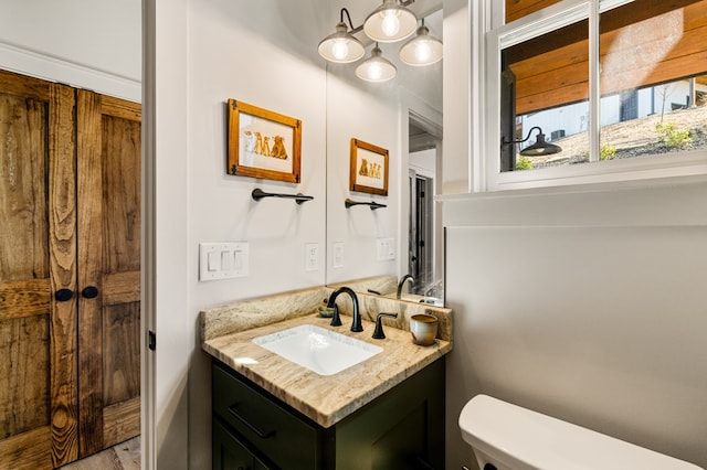 bathroom featuring vanity and toilet